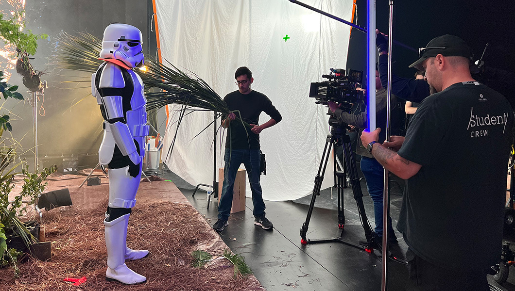 Full Sail’s Studio V1 soundstage is set up to look like the forest planet Endor from ‘Star Wars’ while crew and an actor dressed as Stormtrooper film a scene.